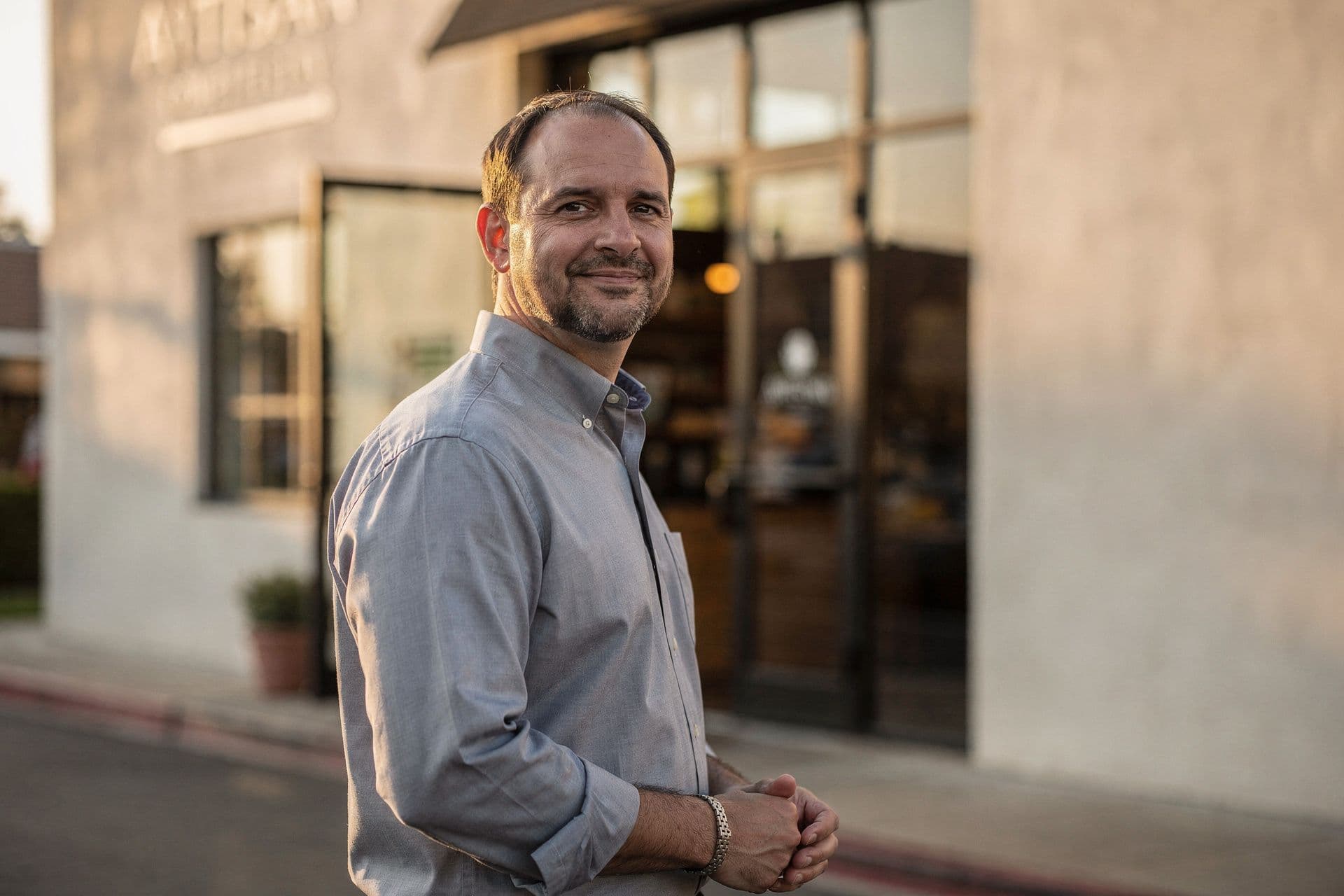 Christopher Kingston, Regional Operations Director of Artisan Hospitality Group a hospitality business in Southern California standing with a composed expression